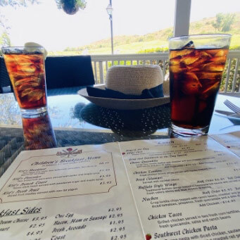 Menu and drinks on a table at The Farmhouse Grill at Strawberry Farms