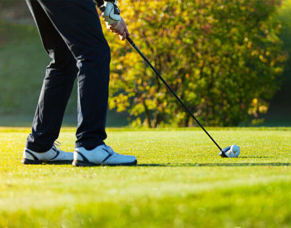 Person playing golf in proper golf attire